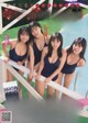 A group of young women standing next to a swimming pool.