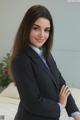 A woman in a business suit posing for a picture.