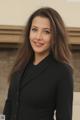 A woman in a black suit posing for a picture.